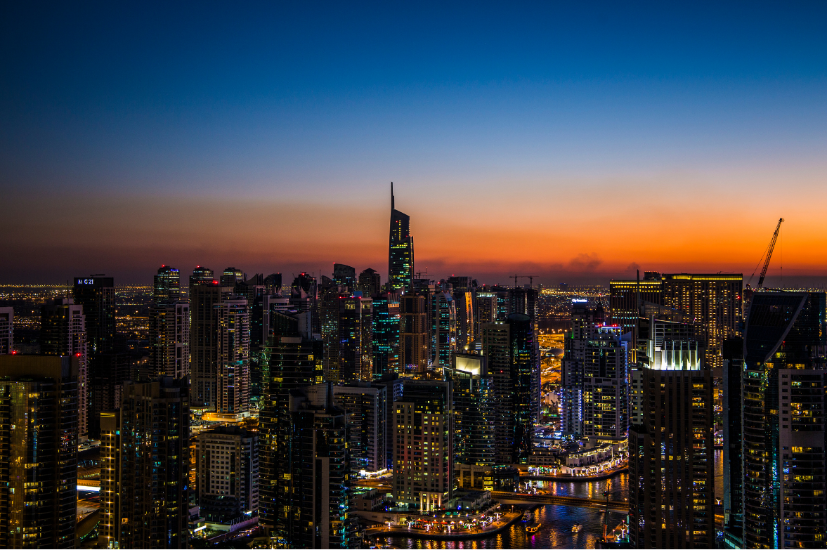 City skyline and illuminated waterfront at dusk